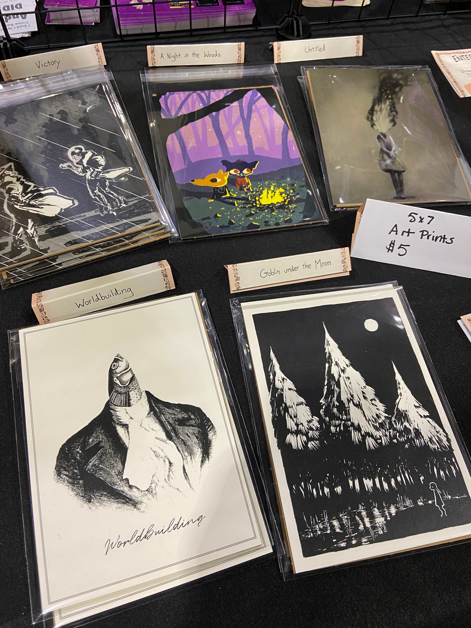 Collection of Turtlebun art prints on a dark tablecloth with labels.